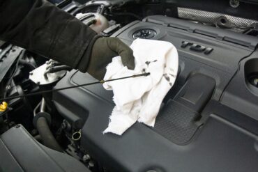 Car mechanic completing an oil change.